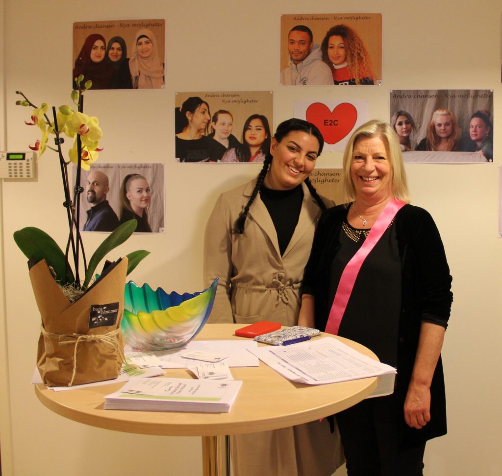 Hiba och Susanne Ramberg står vid bord med blomma.