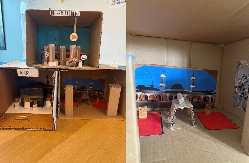 Elevernas byggen av pappkartonger med skyltarna 'de fem pelarna' och 'Kaba'.